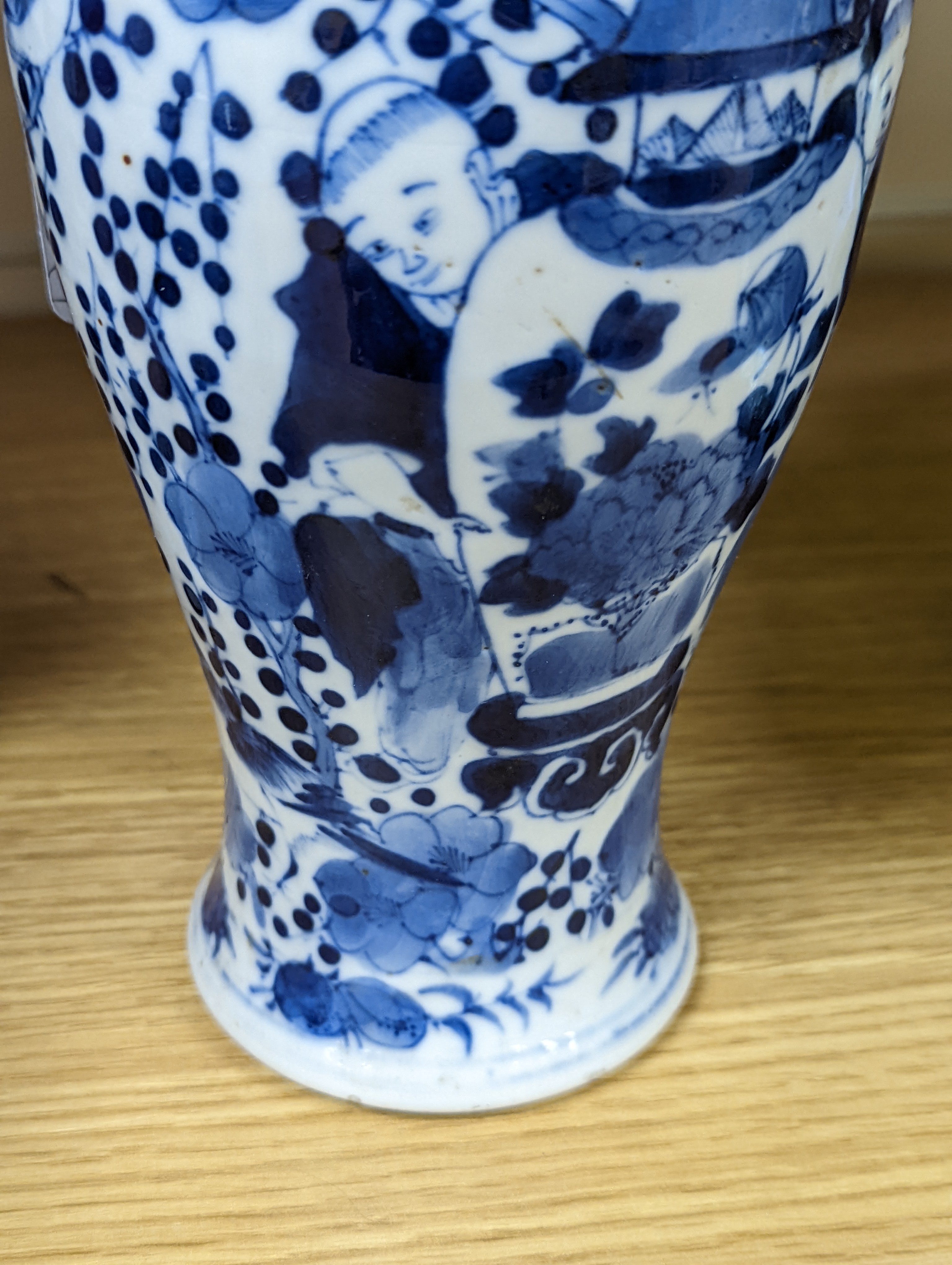 A pair of 19th century Chinese blue and white vases, a prunus vase and cover and a similar jar (4), pair of vases 24 cms high.